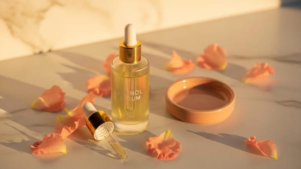 Korean retinol skincare products on a minimalist marble surface with warm lighting